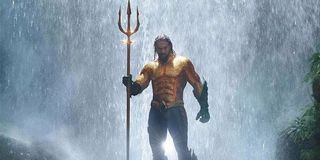 Jason Mamoa as Aquaman aided by the Trident of Neptune