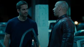Paul Walker and Vin Diesel looking at each other in Fast & Furious
