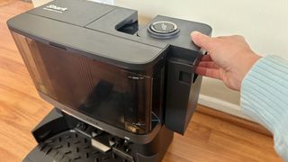 Shark PowerDetect 2-in-1 removing dust bin on NeverTouch Base