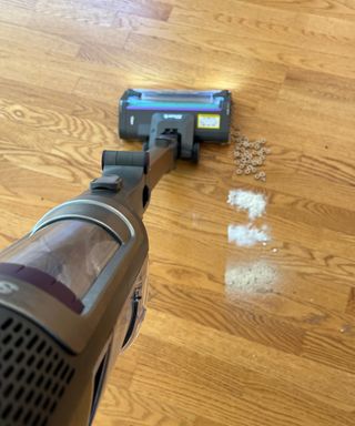 Shark Cordless PowerDetect vacuuming flour, sugar, seasoning and cereal on a hardwood floor