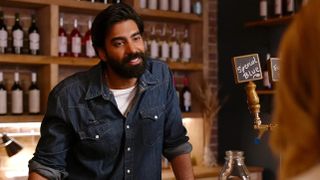 Raymond Ablack as Joe standing in his cafe in Ginny & Georgia