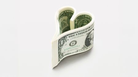 Dollar bills in heart shape