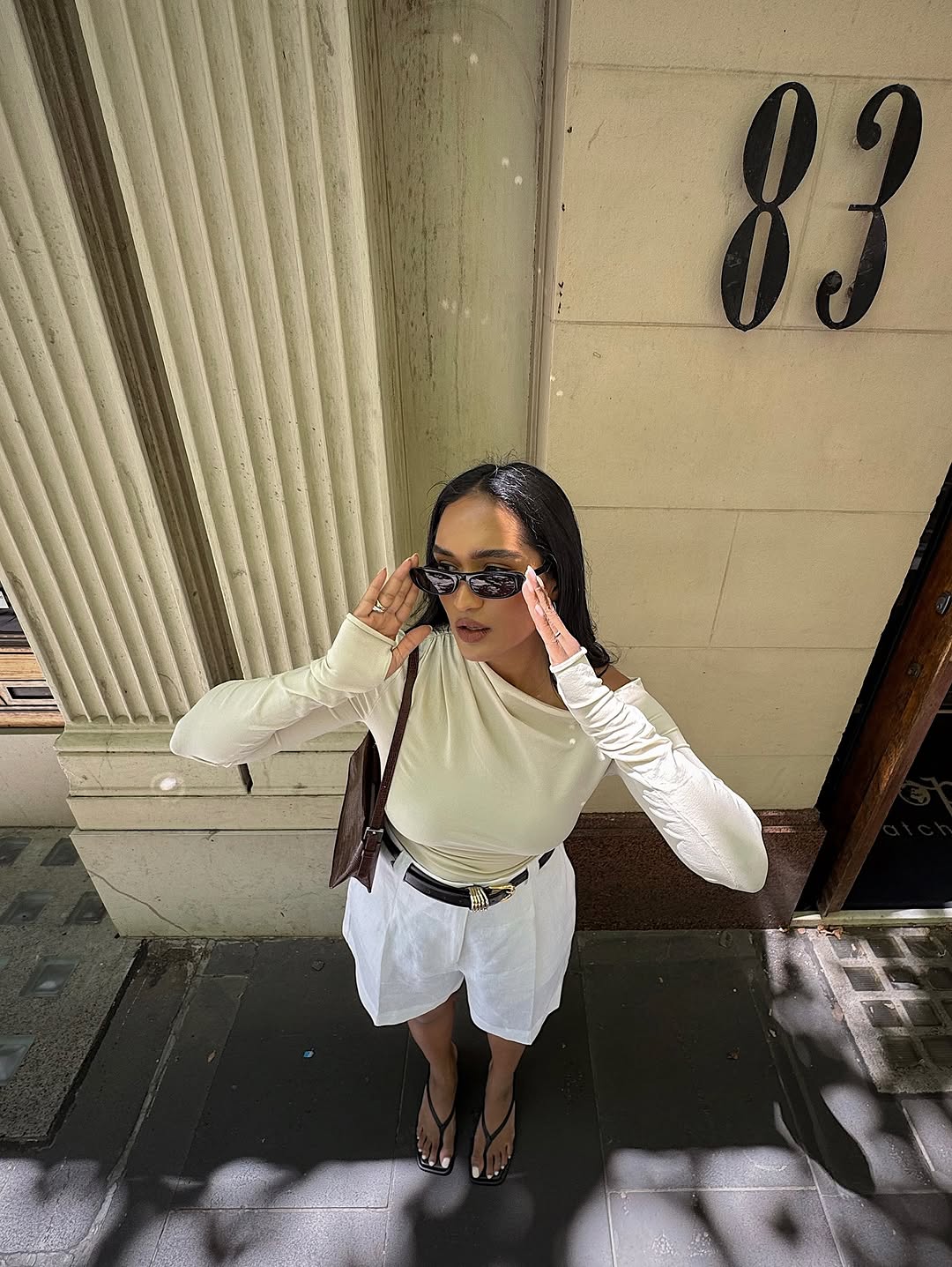 woman wearing white trouser shorts and belt