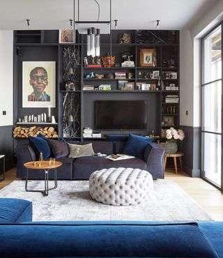 Small dark blue living room with built in shelving and gallery wall
