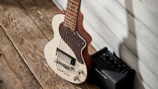 Blackstar Carry-on guitar leaning against wall, with Blackstar fly behind.