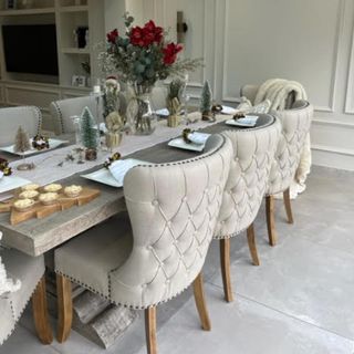 neutral dining room with cream chairs and wood table