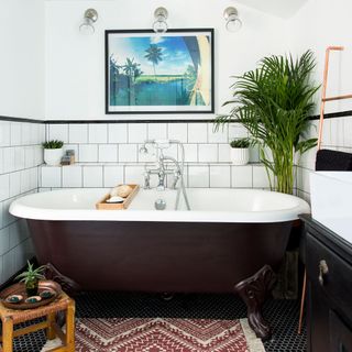 bathroom with brown tub and white wall