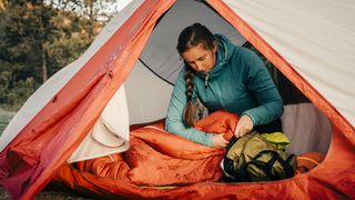 how to wash a sleeping bag: woman sorting bag