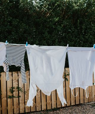 An image of white washing hanging on a washing line in the sun
