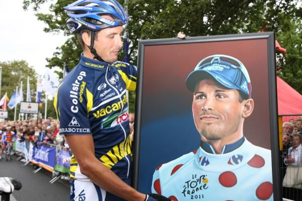 Johnny Hoogerland (Vacansoleil-DCM) holds a painting of himself in the Tour de France's polka dot jersey.