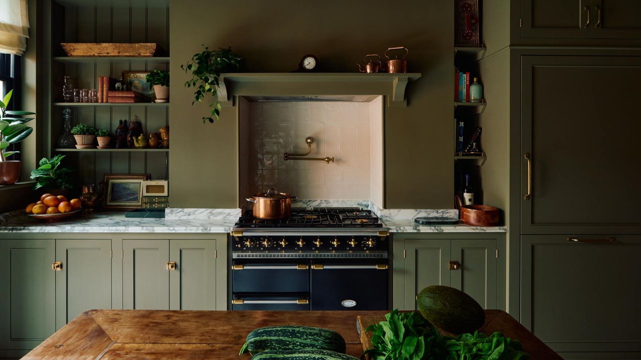 A green color drenched kitchen with low cabinets 