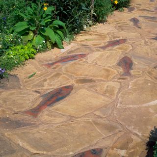 garden pathway with fish painted stones