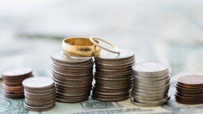 Close up of stacks of coins and wedding rings