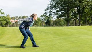 PGA pro Katie Dawkins rolling a ball on a green