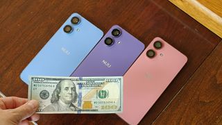 Three different Nuu N20 phones in blue, purple, and pink, with a $100 bill on front of them