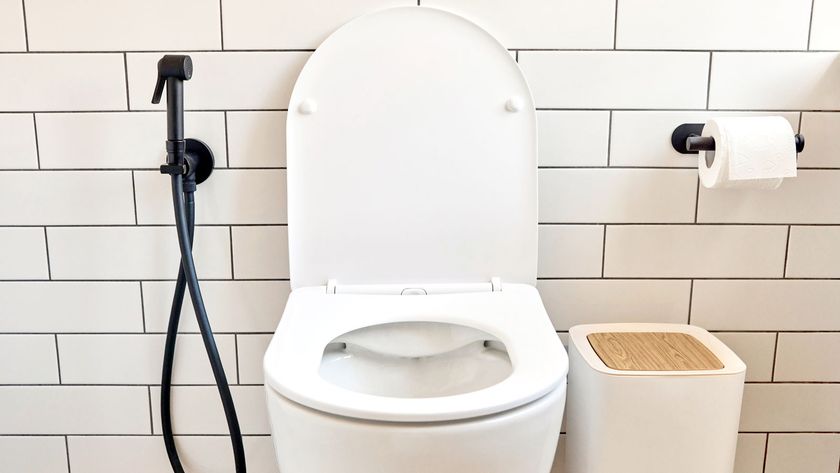 Contemporary white toilet with a background of white metro tiles and grey grout