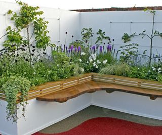 raised bed of flowers and plants in apartment garden