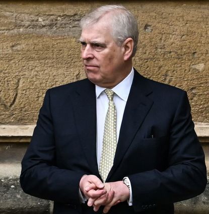Prince Andrew standing in front of a wall