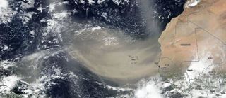 A massive dust plume from the Sahara Desert reaches far out over the Atlantic Ocean, stretching across 2,000 miles, in this view from the NASA-NOAA Suomi NPP Earth-observing satellite on June 13, 2020.