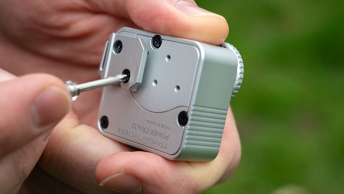 Close-up of TTArtisan Light Meter II rear, with hand using screwdriver to turn a screw
