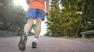 Person running with blue shorts