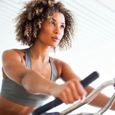 A woman on an exercise bike at the gym