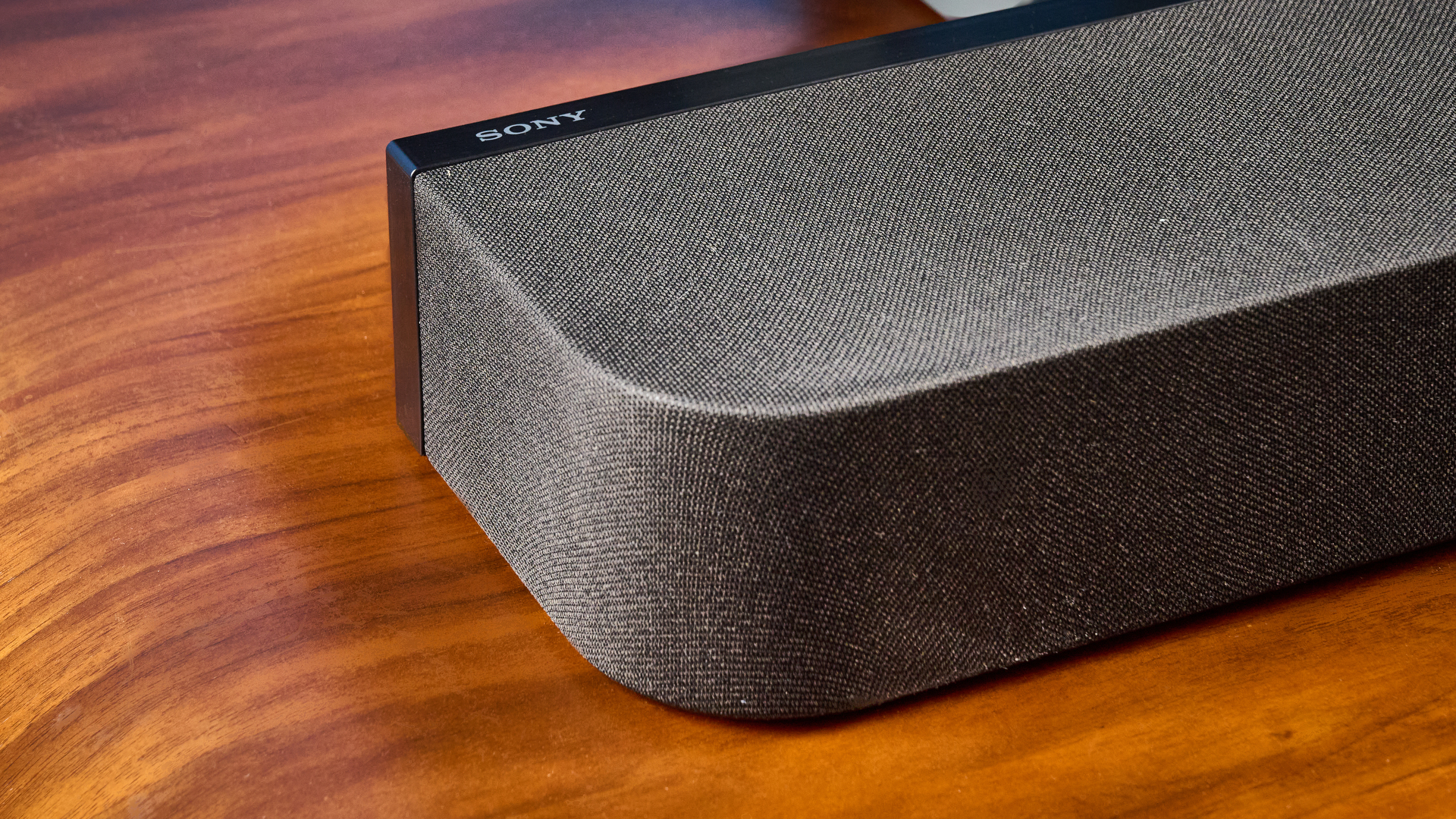 the sony bravia theater bar 7 photographed with the subwoofer with a TV on the tom's guide blue background