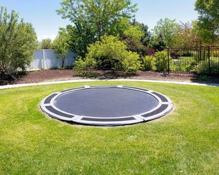 In-ground trampoline on a lawn at the backyard