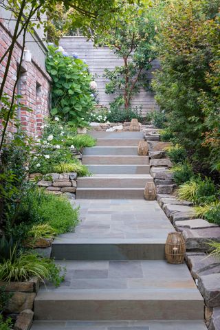 A front yard path elevated with flowers either side of the path