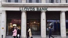 Pedestrians walk past a Lloyds Banking Group branch in Moorgate.