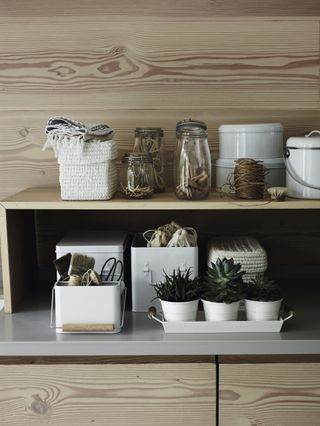Storage jars used to organise a shed, pegs, twine, tags and other gardening essentials stored by the white company