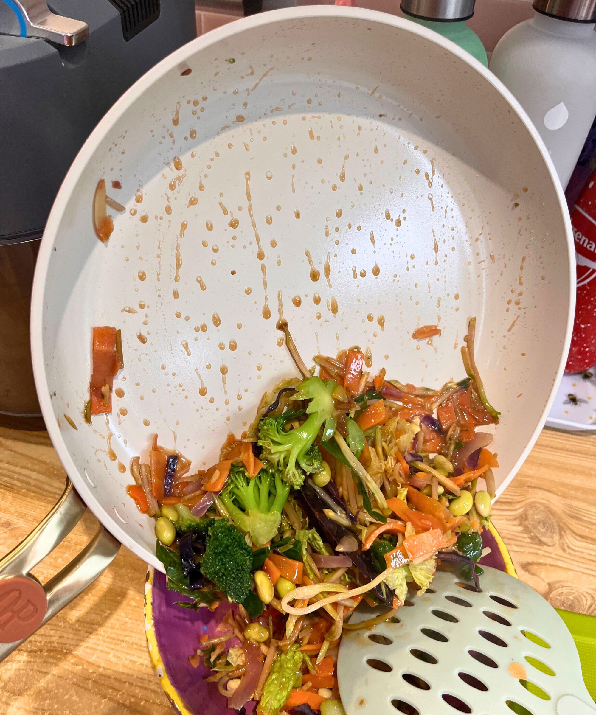 I cooked stir-fry in the frying pan of the Our Place Essentials Cookware set and it is pictured here sliding off the pan into my bowl with no sticking or marks
