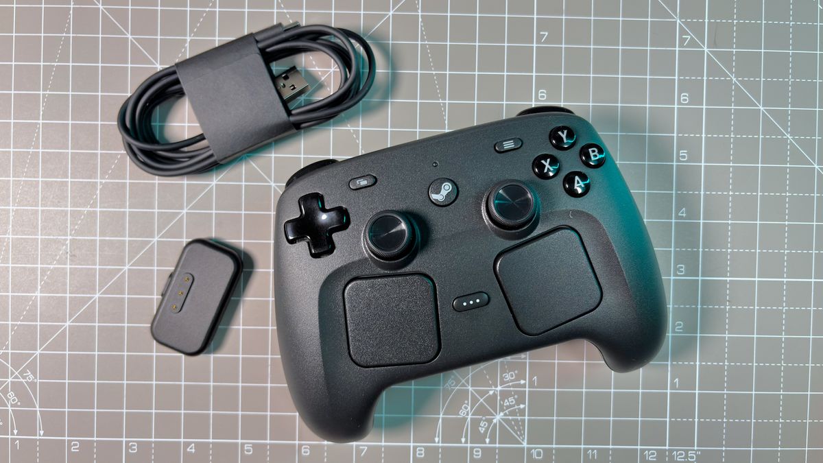 The Steam Controller on a desk during a teardown, with various parts removed.