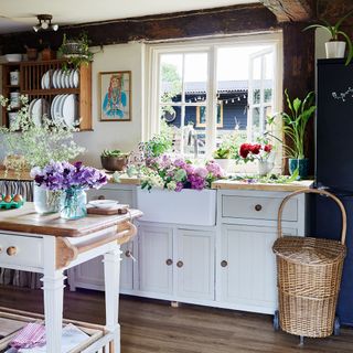 country style kitchen with white cabinets and freestanding island and basket
