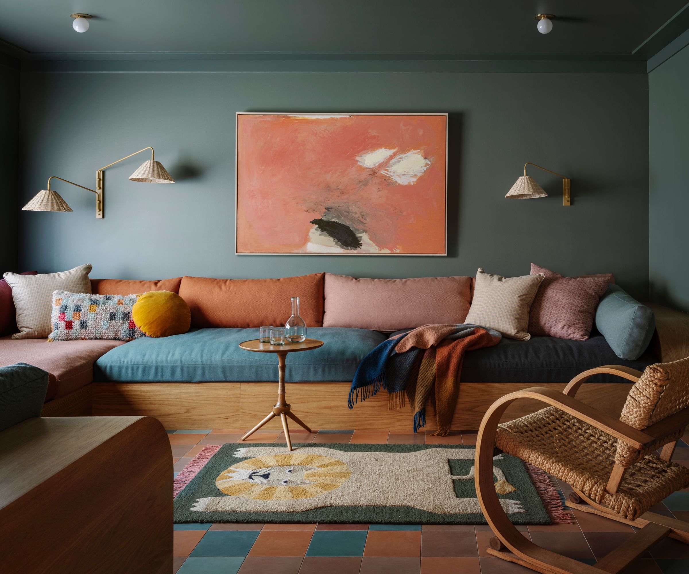 moody teal color drenched family room with a built in couch