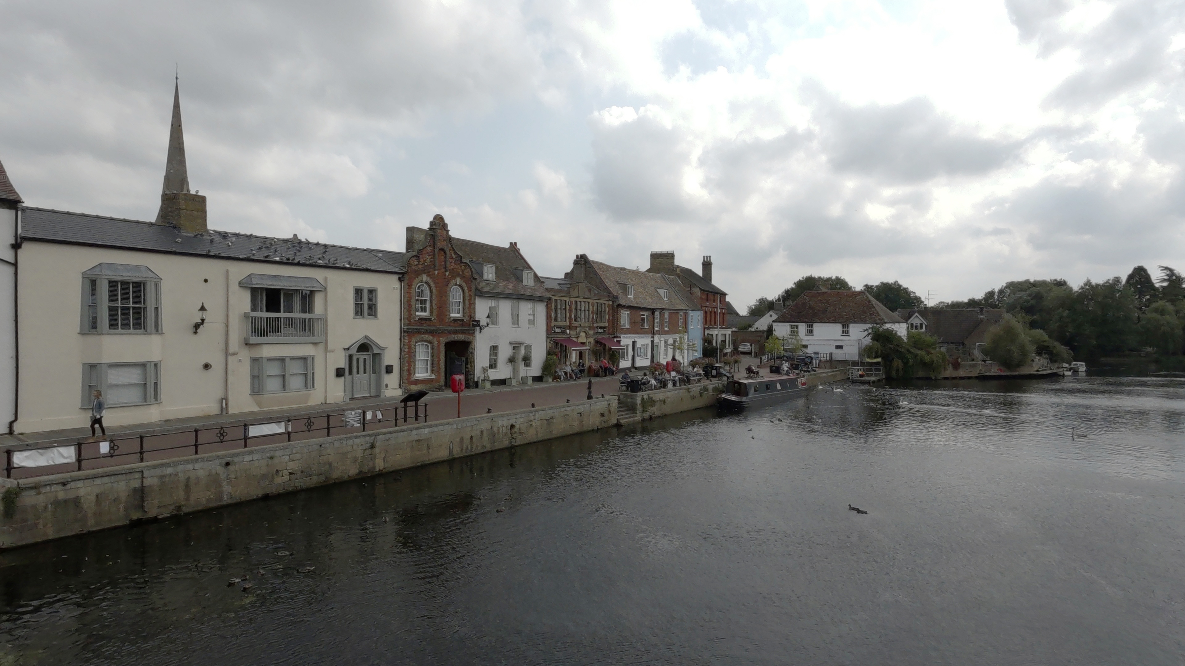 A series of shops and houses lining a river shot on a Kandao QooCam 3 Ultra 360 camera