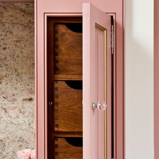 pink open door cupboard wooden drawer