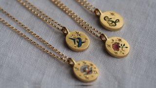 Some of Cece's 18ct gold pendants with enamel design and diamonds, £1950
