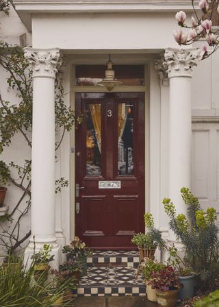 Front door of traditional house painted red