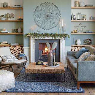 blue walls in living room with alcoves on either side of fireplace