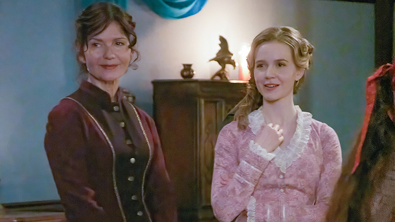 Jill Hennessy and Roan Curtis rock red and pink 1800s gowns in a Season 1 episode of Hope Valley: 1874.
