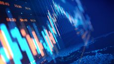IT spending concept image showing financial market graphs with fluctuating growth trajectory.