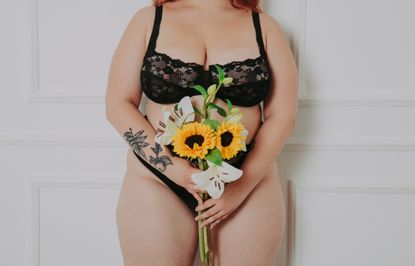 Sustainable periods: A woman stands in her underwear with a bunch of flowers