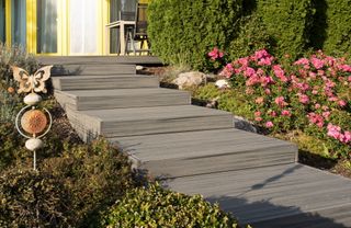 Decking steps surrounded by garden flowers