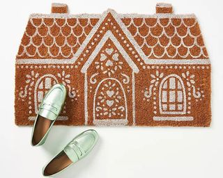 Gingerbread house coconut coir doormat with mint green metallic loafer style shoes