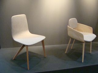 Two light-wood chairs, one with no arms and one with arms.