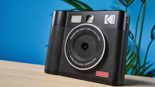 A black Kodak Mini Shot 4 Era 2-in-1 instant camera and printer