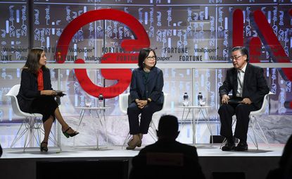 3 people on stage being interviewed 