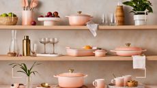 Kitchen shelves filled with the new Le Creuset Peche colour cookware and kitchen essentials