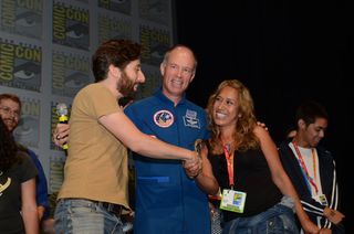 "The Big Bang Theory" star Simon Helberg (left), XCOR Chief Test Pilot/former NASA astronaut Rick Searfoss and Mercedes Becerra of Paso Robles, Calif., winner of the trip to space given away at "The Big Bang Theory" panel at Comic-Con 2012 on July 13.